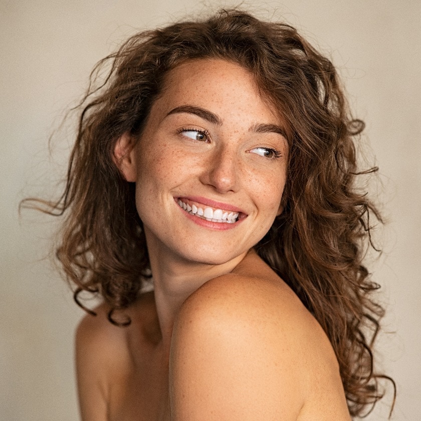Smiling beauty woman with freckles looking away